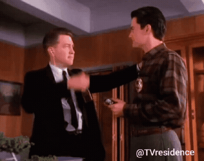 Two Men Standing One Wearing Headphones GIF