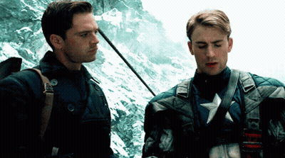 Two Men Standing One With Star On Chest GIF