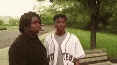 Two Men Standing Together In Park GIF