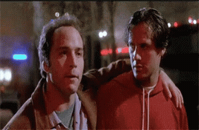 Two Men Standing Together One In Red Hoodie GIF