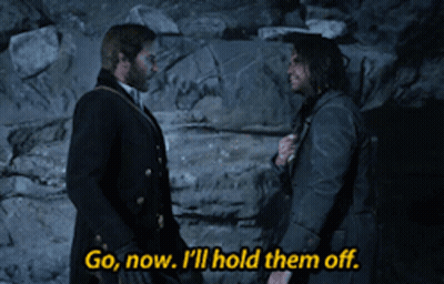 Two Men Standing Together Saying Go Now I'll Hold Them Off GIF