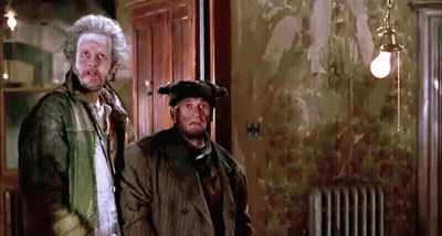 Two Men Standing Under Light Bulb GIF