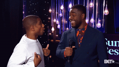 Two Men Standing With Bet Logo GIF