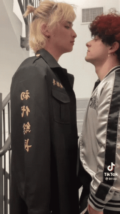 Two Men Standing With Chinese Writing Jacket GIF