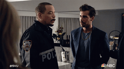 Two Men Standing With Police Patch GIF