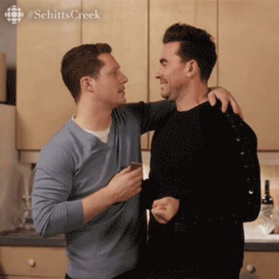 Two Men Standing With Schitts Creek GIF