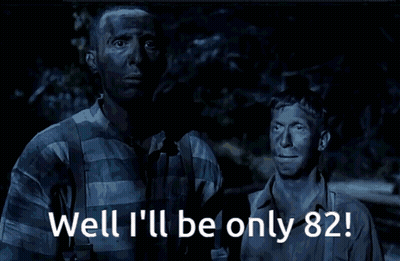 Two Men Standing With Well Ill Be Only 82 GIF