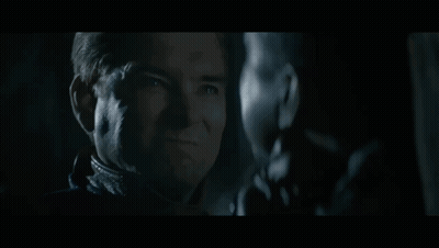 Two Men Staring In Dark One Smiling GIF
