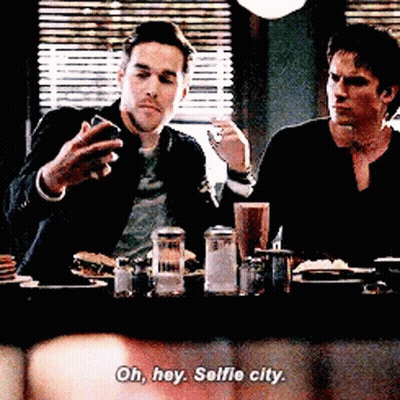 Two Men Taking Selfie at Diner Table