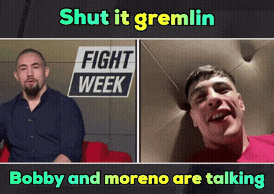 Two Men Talking At Fight Week Sign GIF