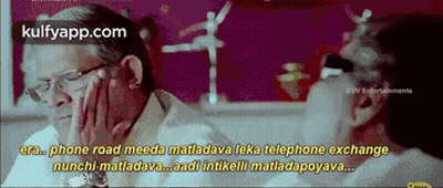 Two Men Talking At Table In Movie Scene GIF