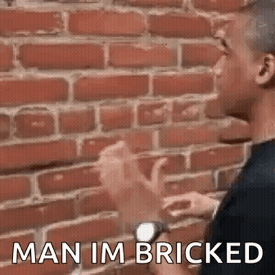 Two Men Talking By Brick Wall GIF