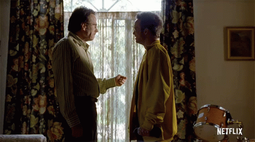 Two Men Talking In A Room With A Netflix Logo On The Bottom Right GIF