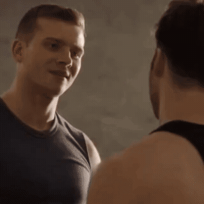 Two Men Talking In Dark Room GIF