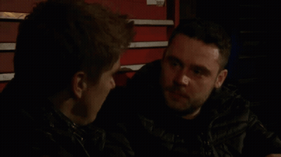 Two Men Talking In Dark Room By Red Toolbox GIF