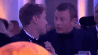 Two Men Talking in Dark Room