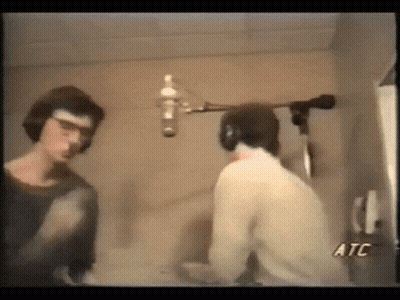 Two Men Talking In Front Of Microphone ATC GIF