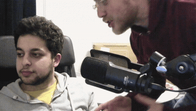 Two Men Talking In Front Of NCR-Lab Microphone GIF