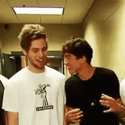 Two Men Talking In Hallway GIF