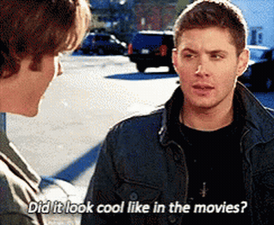 Two Men Talking In Parking Lot Asking If It Looked Cool Like In Movies GIF