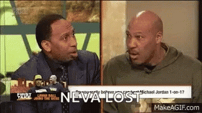 Two Men Talking On TV Show With Neva Lost Behind Them GIF