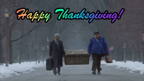 Two Men Walking Down A Snowy Street With The Words Happy Thanksgiving Written Above Them GIF