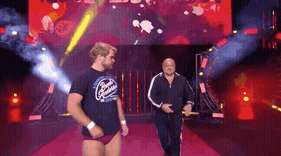 Two Men Walking Down Red Carpet In Front Of Screen GIF