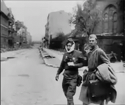 Two Men Walking Down Street GIF