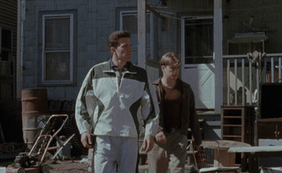 Two Men Walking In Front Of Lawn Mower GIF