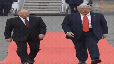 Two Men Walking On Red Carpet, One In Red Tie GIF
