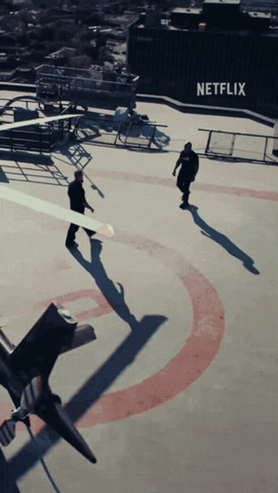 Two Men Walking On Roof With Netflix Logo GIF