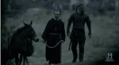 Two Men Walking With Horse And History Sign GIF
