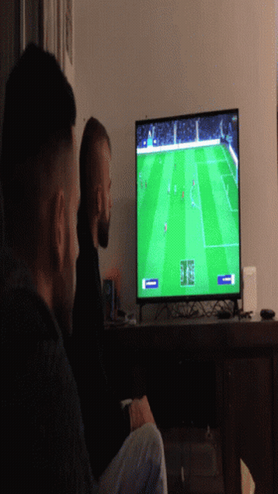 Two Men Watching Soccer On Flat Screen TV GIF
