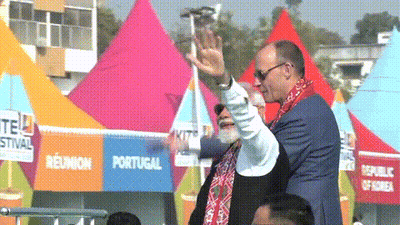 Two Men Waving In Front Of Portugal Tent GIF