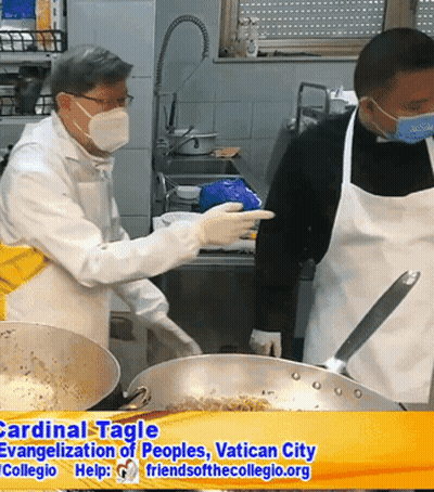Two Men Wearing Aprons And Face Masks Cooking In A Kitchen GIF