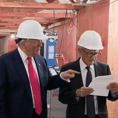 Two Men Wearing Hard Hats Are Standing In Front Of A Building That Says 270 On It GIF
