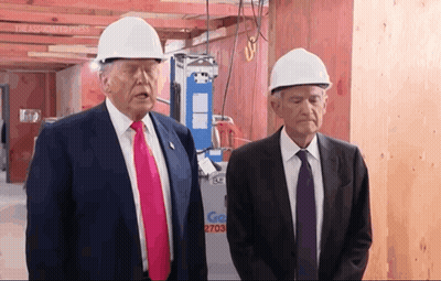 Two Men Wearing Hard Hats Are Standing In Front Of A Sign That Says Go 2703 GIF