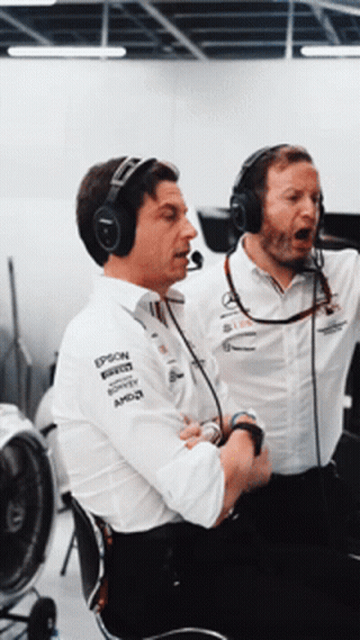 Two Men Wearing Headphones And Shirts That Say Epson Are Sitting Next To Each Other GIF