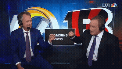 Two Men Wearing Headphones Are Sitting In Front Of A Screen That Says Samsung Galaxy GIF