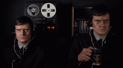 Two Men Wearing Headphones Are Standing In Front Of A Record Player That Says ' Pioneer ' On The Front GIF