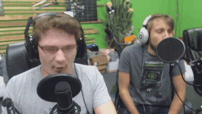 Two Men Wearing Headphones Are Talking Into Microphones In Front Of A Green Screen GIF