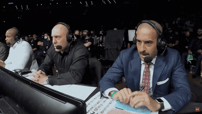 Two Men Wearing Headphones Sitting With UFC Sign GIF