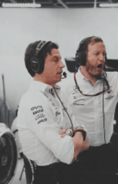 Two Men Wearing Mercedes Shirts And Headphones GIF