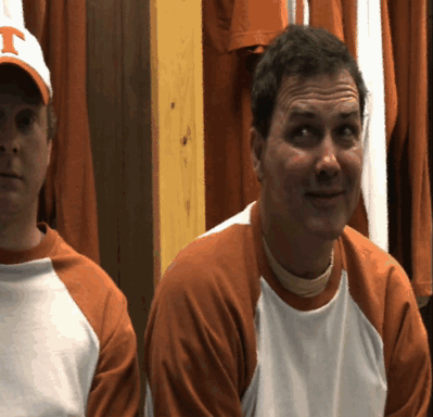 Two Men Wearing Orange And White Shirts With The Letter T On Their Hats GIF