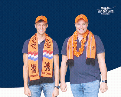 Two Men Wearing Orange Scarves That Say Holland Are Standing Next To Each Other GIF