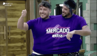 Two Men Wearing Purple Shirts That Say Mercado Extra Are Hugging Each Other GIF