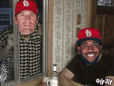 Two Men Wearing St Louis Cardinals Hats Are Looking Out Of A Window GIF
