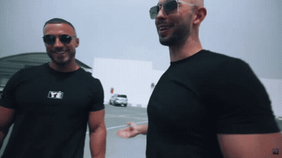 Two Men Wearing Sunglasses And Black Shirts With Ye On Them GIF