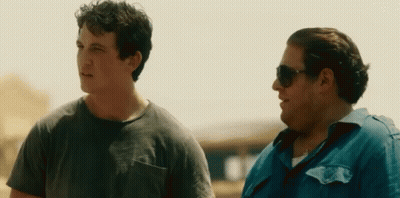 Two Men Wearing Sunglasses Are Standing Next To Each Other . GIF