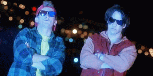 Two Men Wearing Sunglasses Are Standing Next To Each Other GIF